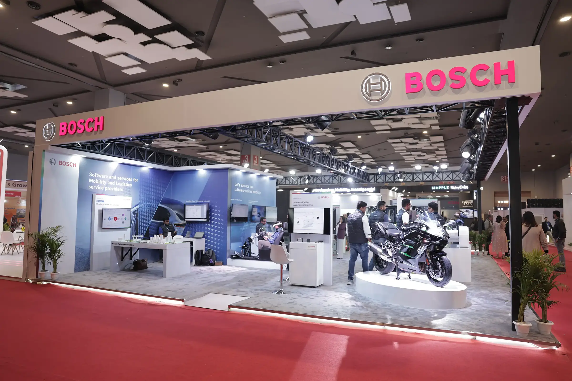 A view of the Bosch booth at BMGE, with a motorcycle displayed prominently.